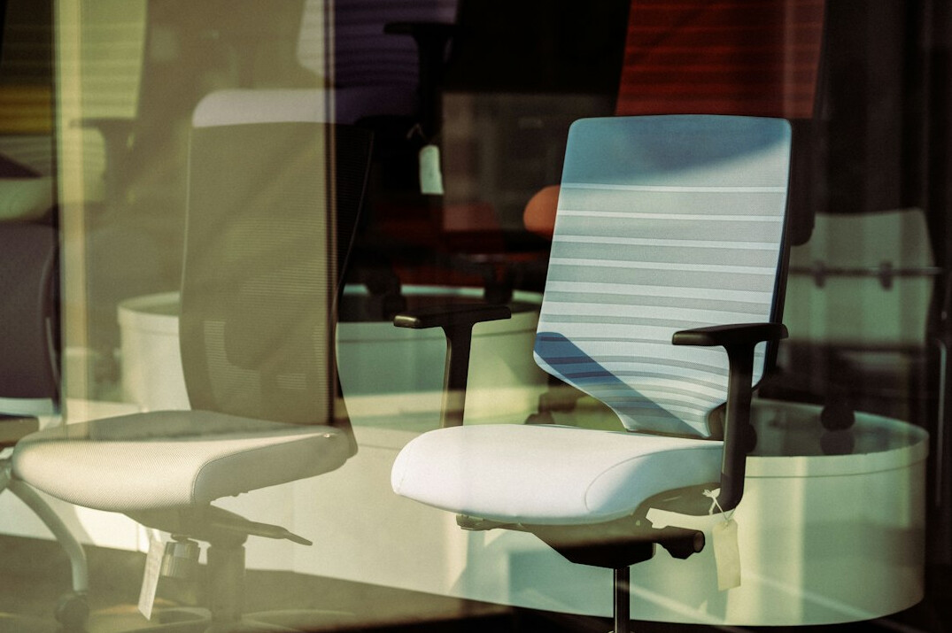 Bright empty office room with ergonomic chairs